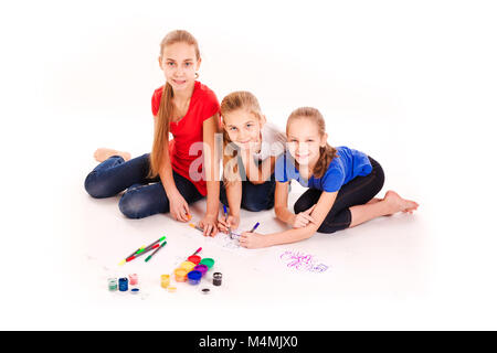 Happy kids drawing isolated on white. Team work, creativity concept. Stock Photo