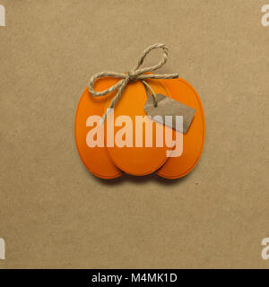 Creative thanksgiving day concept photo of pumpkin made of paper on brown background. Stock Photo