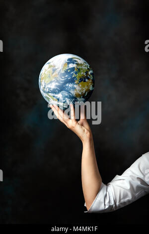 Woman holding the planet earth in her hand Stock Photo