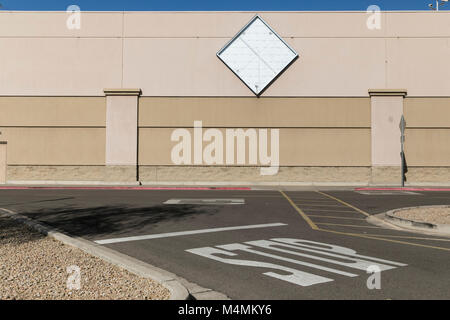 The outline of a logo sign outside of a recently closed Sam's Club warehouse club store in Scottsdale, Arizona, on February 4, 2018. Stock Photo