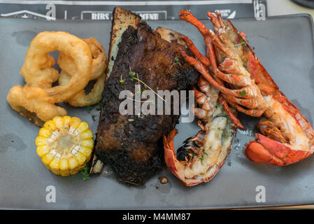 Surf and Turf, grilled canadian lobster and grilled beef ribs Stock Photo