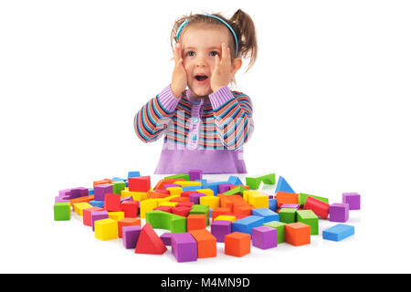 Montessori concept with cute girl playing wooden cubes isolated on white background. Stock Photo