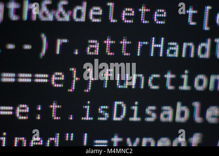 White Program Source Code Segment on Black Screen Macro Closeup Stock Photo