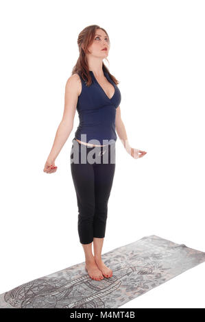 Young sporty woman standing vertical Split Pose practicing yoga at