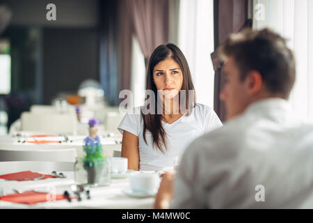 Empathetic emotional woman listening about bad news,problems.Sad woman feeling absent and not interested.Doubting fidelity.Evaluating judging person.B Stock Photo