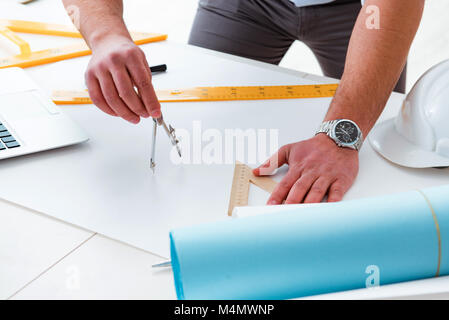 Male engineer working on drawings and blueprints Stock Photo