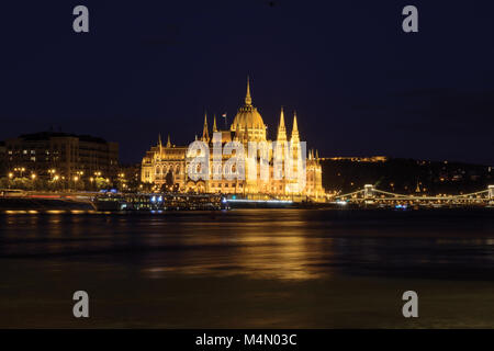 Parliament building reflecting in Danube river at night, Budapest Stock Photo
