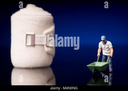 Bandage used for injuries during work, leisure time or in housework, isolated on glossy black background Stock Photo