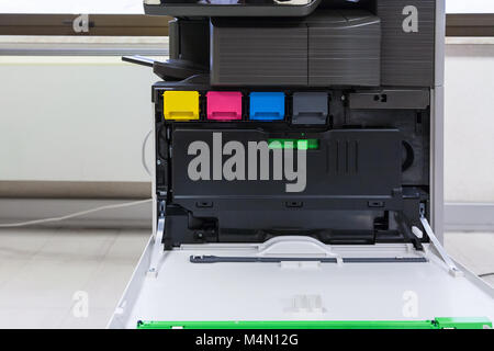 copier with four toner cartridges with open cover in office hall Stock Photo