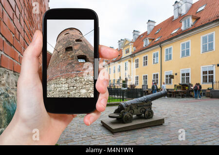 travel concept - tourist photographs Powder Tower, the part of old town walls, in Riga city in Latvia in september on smartphone Stock Photo