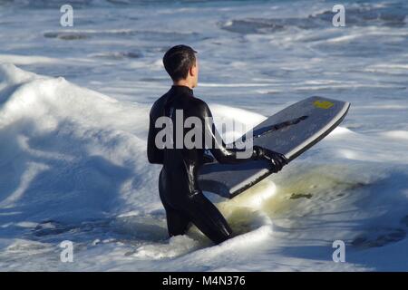 Male Bodyboarder Surfing the North Sea Waves at Aberdeen Beach, Scotland, UK. Winter 2018. Stock Photo