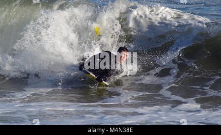 Daring Male Bodyboarder Surfing the Cold North Sea Waves at Aberdeen Beach, Scotland, UK. Winter 2018. Stock Photo