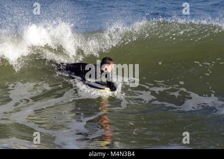 Daring Male Bodyboarder Surfing the Cold North Sea Waves at Aberdeen Beach, Scotland, UK. Winter 2018. Stock Photo