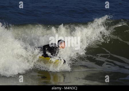 Daring Male Bodyboarder Surfing the Cold North Sea Waves at Aberdeen Beach, Scotland, UK. Winter 2018. Stock Photo