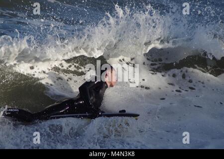 Daring Male Bodyboarder Surfing the Cold North Sea Waves at Aberdeen Beach, Scotland, UK. Winter 2018. Stock Photo