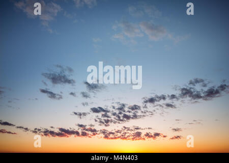 Sunset sky with sparse clouds in the evening Stock Photo