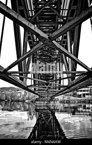 Riveted bridge seen from underneath. Black and white high contrast Stock Photo