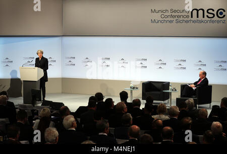 Munich, Germany. 17th Feb, 2018. British Prime Minister Theresa May (L) addresses the Munich Security Conference (MSC) in Munich, Germany, on Feb. 17, 2018. Theresa May called for talks with European Union (EU) about a new security treaty after London left the bloc. Credit: Luo Huanhuan/Xinhua/Alamy Live News Stock Photo