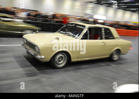 London, UK. 17th Feb, 2018. A 1967 Ford Lotus Cortina 3.5 Litre DOHC Twin Turbo V8 being driven in the daily promenade on the Grand Parade at the London Classic Car Show which is taking place at ExCel London, United Kingdom.  More than 700 of the world's finest classic cars are on display at the show ranging from vintage pre-war tourers to a modern concept cars. The show brings in around 37,000 visitors, ranging from serious petrol heads to people who just love beautiful and classic vehicles. Credit: Michael Preston/Alamy Live News Stock Photo