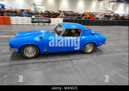London, UK. 17th Feb, 2018. A 1965 Ian Walker Racing Lotus Elan Coupé being driven in the daily promenade on the Grand Parade at the London Classic Car Show which is taking place at ExCel London, United Kingdom.  More than 700 of the world's finest classic cars are on display at the show ranging from vintage pre-war tourers to a modern concept cars. The show brings in around 37,000 visitors, ranging from serious petrol heads to people who just love beautiful and classic vehicles. Credit: Michael Preston/Alamy Live News Stock Photo