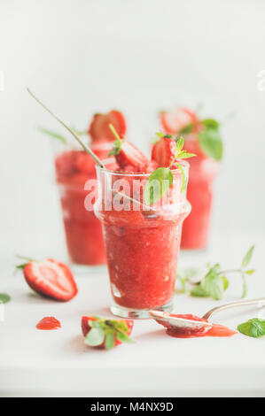 Healthy low calorie summer treat. Strawberry and champaigne granita, slushie or shaved ice dessert in glasses, white background. Clean eating, weight Stock Photo