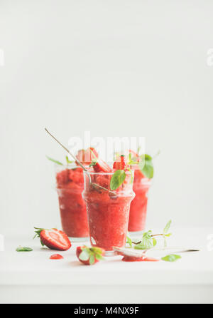 Healthy low calorie summer treat. Strawberry and champaigne granita, slushie or shaved ice dessert in glasses, white background, copy space. Clean eat Stock Photo