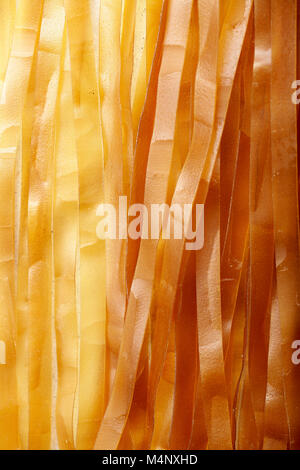 Close up shot of flat and thick rice noodles made with coconut milk. Traditional chinese cuisine ingredient. Stock Photo