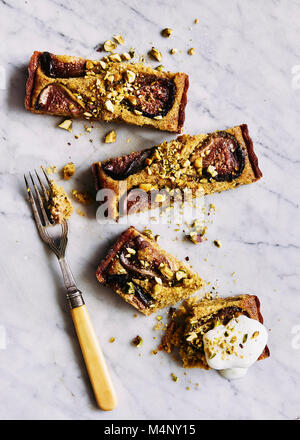 Fig and Pistachio nut frangipane tart on marble background. Stock Photo