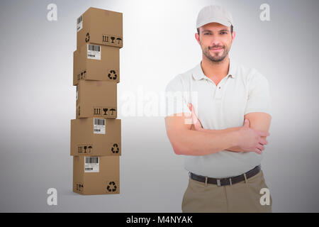 Composite image of delivery man standing arms crossed Stock Photo