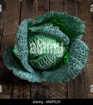 fresh savoy cabbage closeup on rustic wooden background Stock Photo