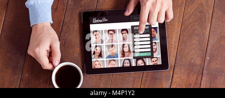 Composite image of man using digital tablet while having cup of coffee Stock Photo
