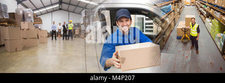 Composite image of delivery driver offering parcel from his van Stock Photo