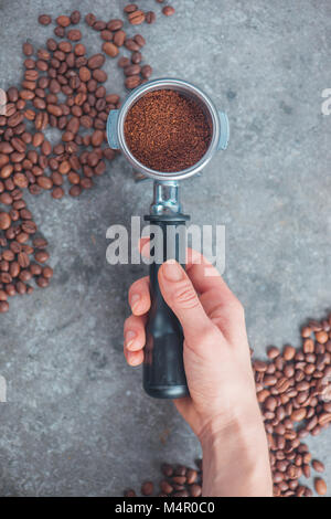 barista holding tamper near portafilter with grinded coffee, espresso, manual  press Stock Photo by LightFieldStudios