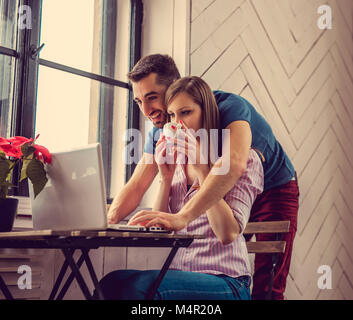 Multi ethnic student using laptop in apartments. Stock Photo