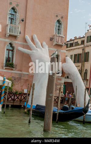 VENICE, ITALY - August 2017: Monumental hands rise from the water in Venice to highlight climate change Stock Photo