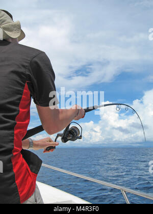 big game fishing, deep sea fishing, fisherman in a boat fight against a fish Stock Photo