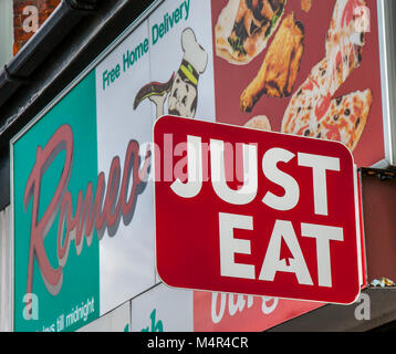 Just Eat advertising sign on front of pizza restaurant, Southport, UK Stock Photo