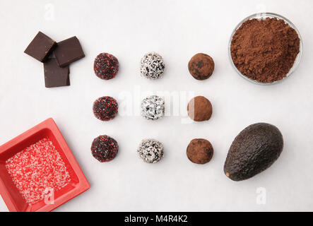 variety of cacao truffles and ingredients on white tabletop Stock Photo