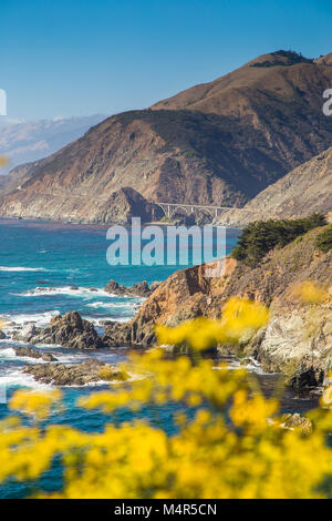 Scenic view of the rugged coastline of Big Sur with Santa Lucia Mountains and Big Creek Bridge along famous Highway 1 at sunset, California, USA Stock Photo