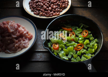 Pieces of chicken, beans. Pepper and chili in a frying pan horizontal Stock Photo