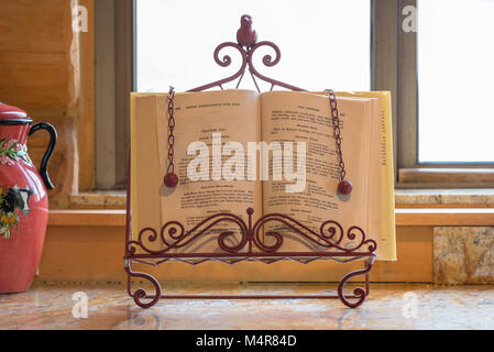 Cookbook in a cookbook holder on a kitchen counter. Stock Photo