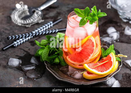 Grapefruit and fresh mint cocktail with juice, cold summer citrus refreshing drink or beverage with ice Stock Photo