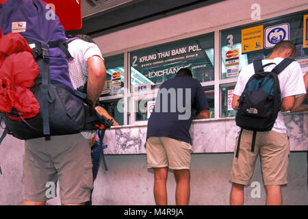 Backpackers at currency exchange, Bangkok, Thailand