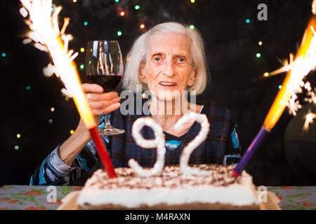 Senior woman toasting on her birthday celebration party Stock Photo