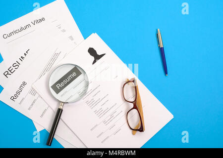 Top View Of Stack Of Resume Filesmagnifier On Black Surfaceconcept