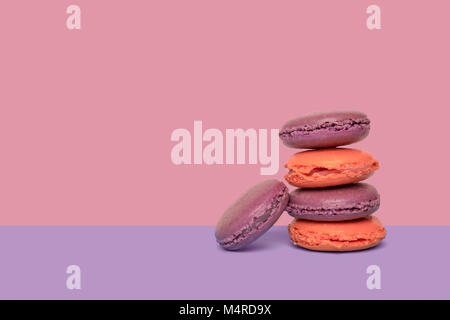 French macarons on pastel violet color background. French dessert macaron. Stock Photo