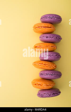 Top view of violet and pink macaron on the blue pastel color background. French dessert macarons Stock Photo