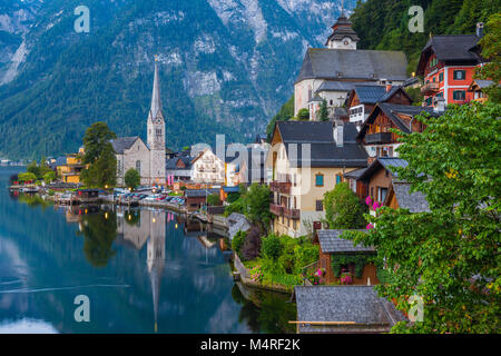 Scenic picture-postcard view of famous historic Hallstatt mountain village with Hallstattersee in the Austrian Alps in mystic twilight during blue hou Stock Photo