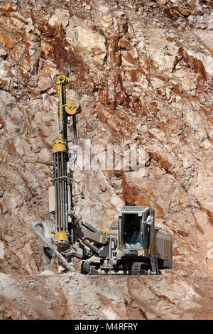 Drilling machine in open cast mining quarry Stock Photo