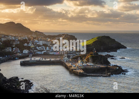 Ilfracombe Harbour at sunset with the Landmark Theatre and Damien Hirst statue Verity Stock Photo